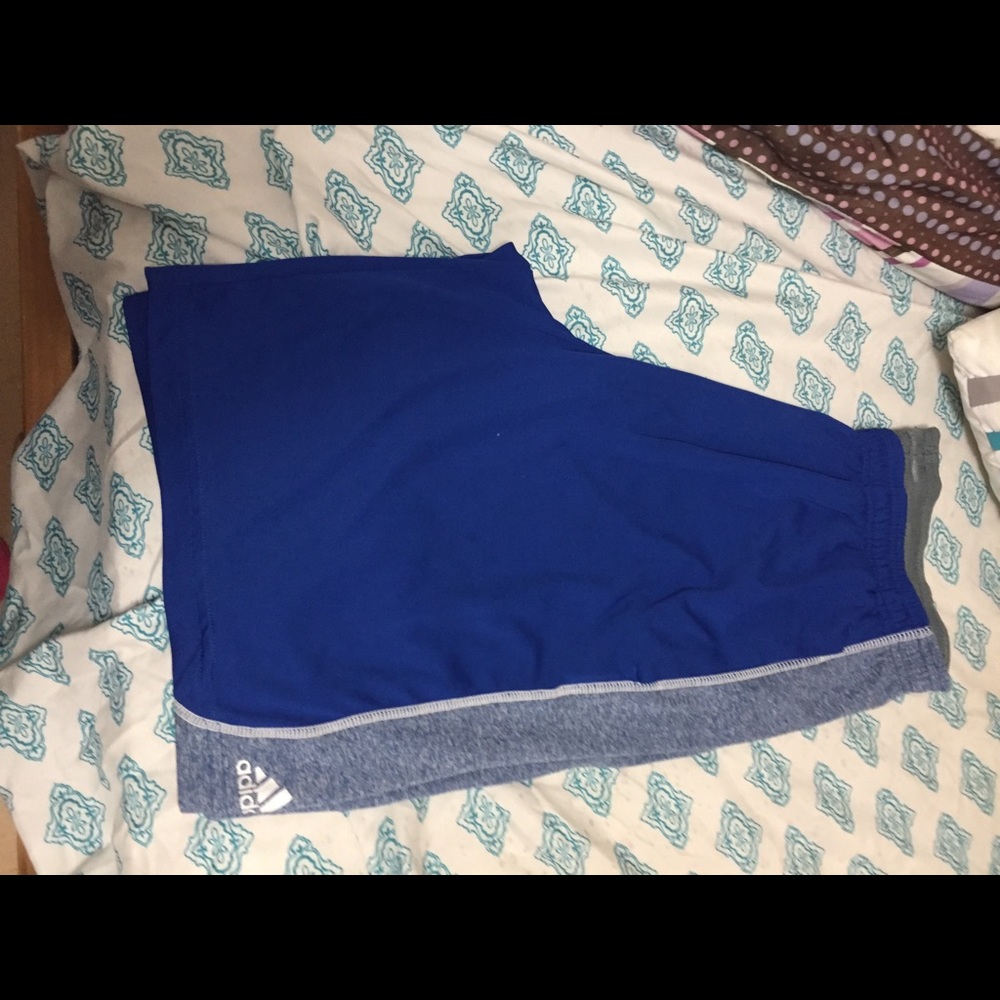Man’s blue Adidas basketball shorts